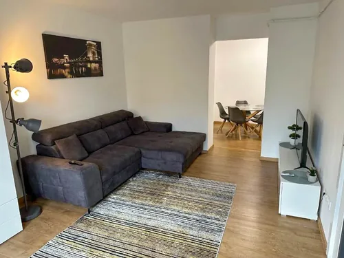 Nappali kanapéval és színes fali képpel